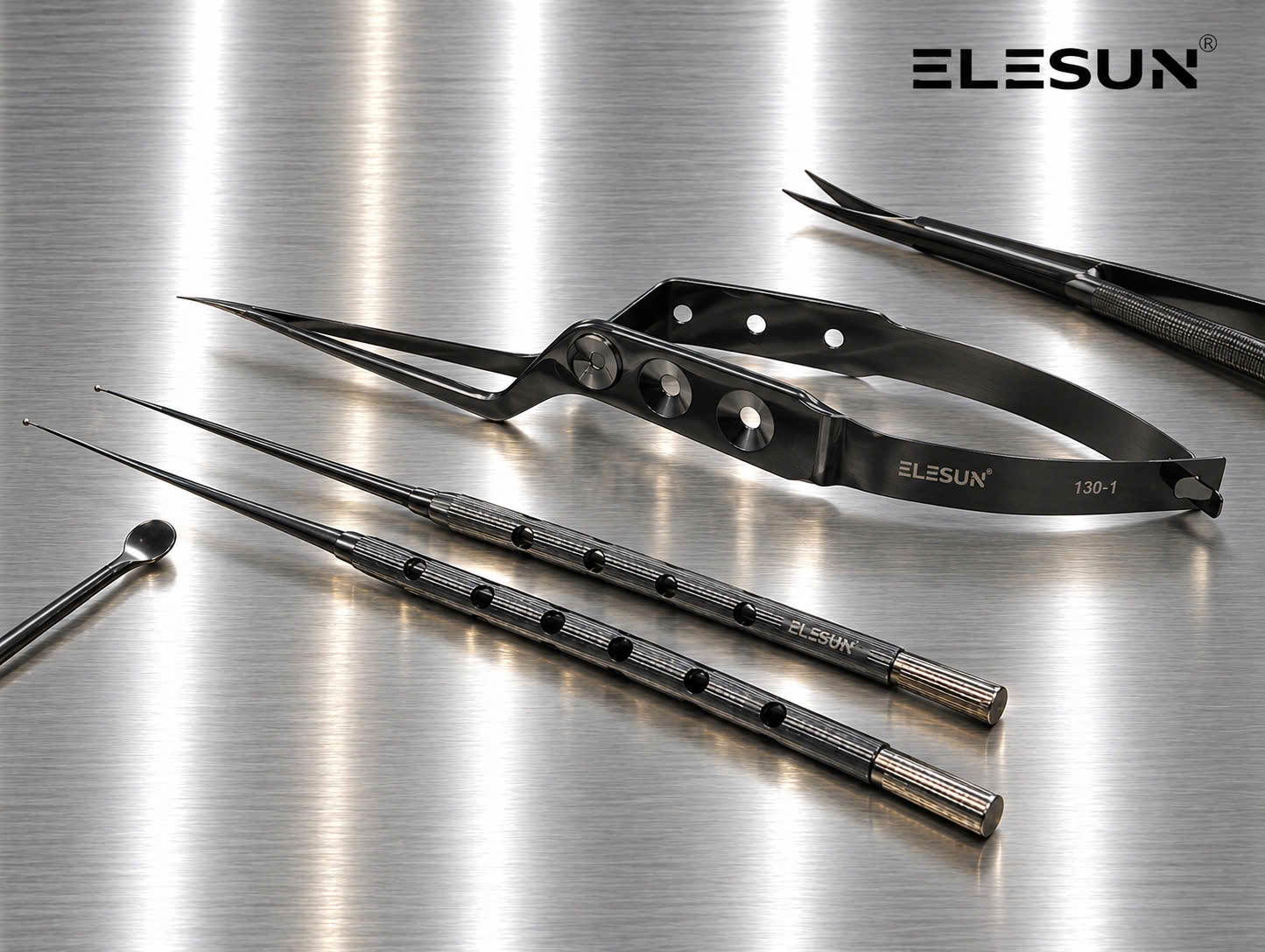 Dark-finish ELESUN microsurgical instruments: a bayonet spring-handle instrument, two round-handled fine instruments with ball tips and a small spoon-tipped instrument